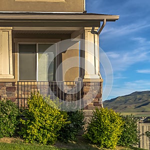 Square Stairs leading to porch and front door with sidelight at the entrance of home