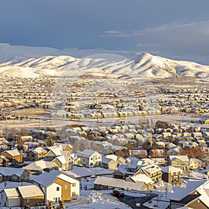 Square Sunset in scenic Utah Valley with homes and mountain covered with winter snow