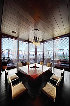 Square table and chairs in empty restaurant photo