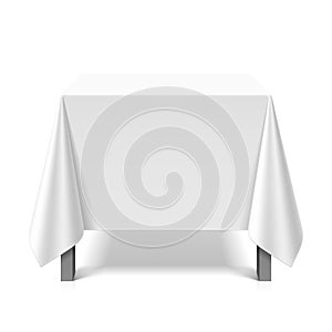 Square table covered with white tablecloth