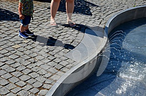 On the square there are spray nozzles in a regular grid which spray upwards according to the program. the girls are fooling around