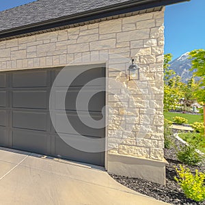 Square Three car garage and driveway of suburban home