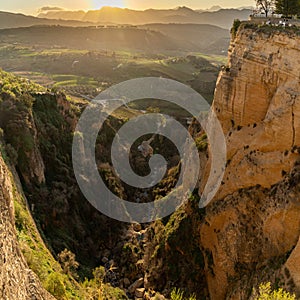 Square view of the El Tajo Gorge and the Albergue Los Molinos in Ronda in southern Spain at sunset photo