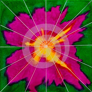 Square watercolor with yellow, orange, purple and green resembling a flower with stripes bursting from the centre.