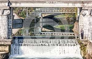 Square waterfall under a bridge photo