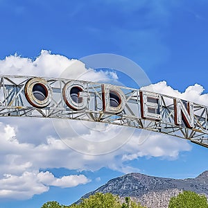 Square Welcome arch at the city of Ogden Utah against vivid blue sky and puffy clouds