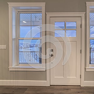 Square White front door flanked by windows interior