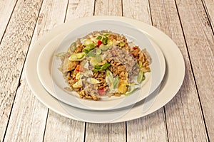 Square white plate of Latin American chaufa rice with vegetables, scrambled eggs photo