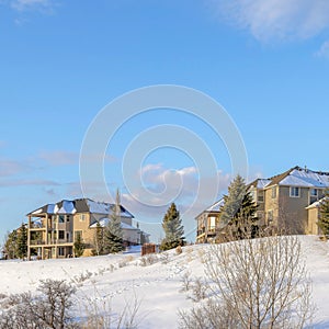 Square White puffy clouds Large residential area on top of a snowy hill at Draper, Utah