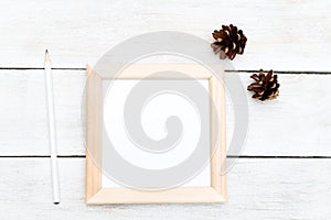 Square wooden frame and bumps on a wooden background. Flat lay