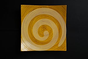 square wooden plate with concentric circles pattern