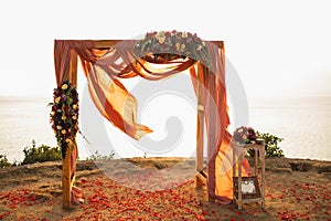Square wooden wedding arch on outdoor sunset red color wedding ceremony