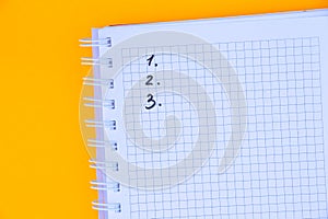 Squared notebook with numbers 123 on an orange background