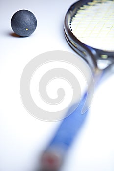 Squash ball and racket on white background