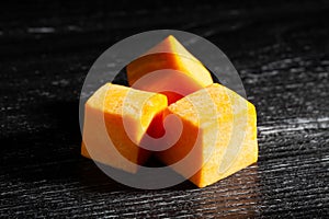 squash chunks on black wood