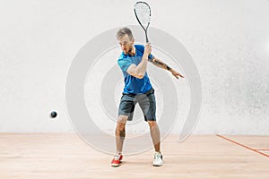 Squash game training, male player with racket
