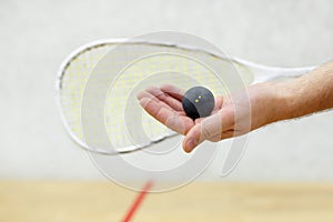 Squash player serving a ball