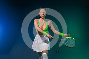 Squash player on a squash court with racket. Man athlete with racket on court with neon colors. Sport concept. Download