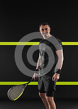 Squash player on a squash court with racket. Man athlete with racket on court. Sports concept. Download a high quality