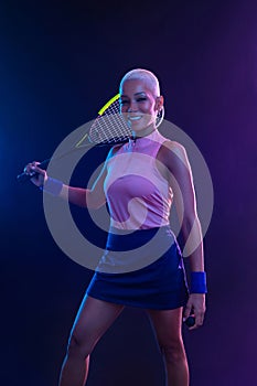 Squash player on a squash court with racket. White sportswear. Beautiful girl teenager and athlete with racket on court