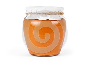 Squash puree in a glass jar on a white background