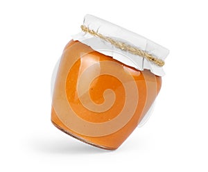Squash puree in a glass jar on a white background