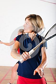 Squash racket sport in gym, women competition