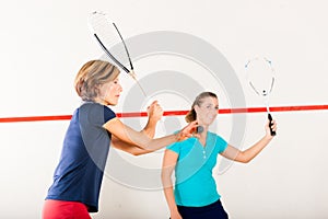 Squash racket sport in gym, women competition