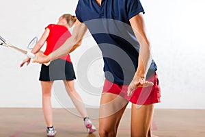 Squash racket sport in gym, women competition