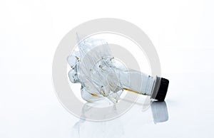 Squashed plastic bottle isolated in the white background