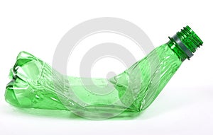 Squashed plastic green bottle