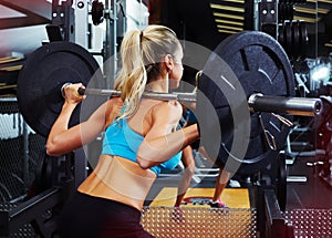 Squat woman with barbell
