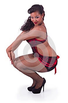 Squatting pinup in red and black