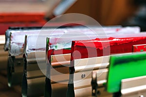 squeegees close-up on wooden shelve of the print screening apparatus. silk screen printmaking. serigraphy production