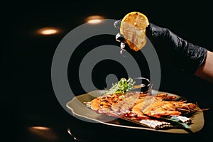 Squeeze a lemon on a langoustines from Hosper