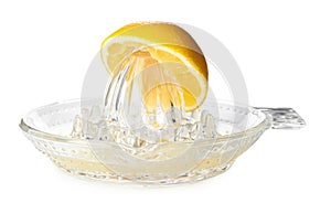Squeezer with lemon and juice on white background