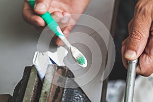 Squeezes toothpaste from tube with vise