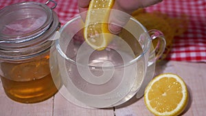 Squeezing a lemon for homemade cold and flu remedy
