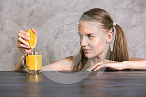 Squeezing orange on table
