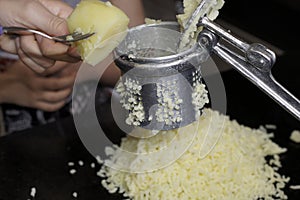 Squeezing potatoes to make gnocchi handmade