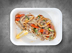 Squid pasta. Healthy food. Takeaway food. Top view, on a gray background