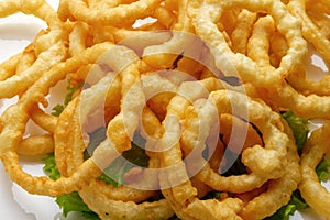 Squid rings in batter on a white