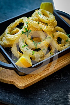 Squid rings deep fried with lemon wedges