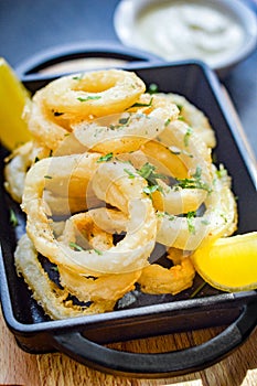 Squid rings deep fried with lemon wedges