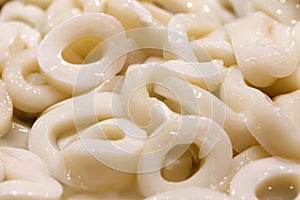 Squid rings, fresh raw many pieces chilled, at the fish market