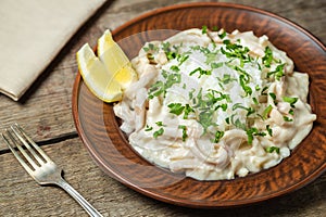 Squid in sour cream sauce. Greek national dish.