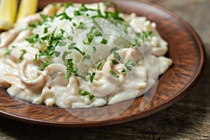 Squid in sour cream sauce. Greek national dish.