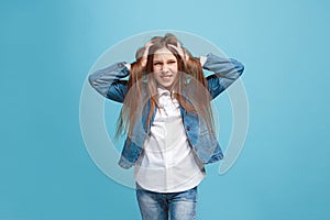 The squint eyed teen girl with weird expression isolated on blue