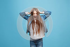 The squint eyed teen girl with weird expression isolated on blue