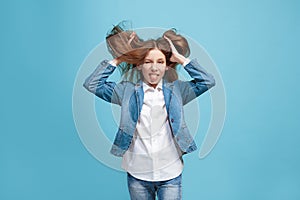 The squint eyed teen girl with weird expression isolated on blue